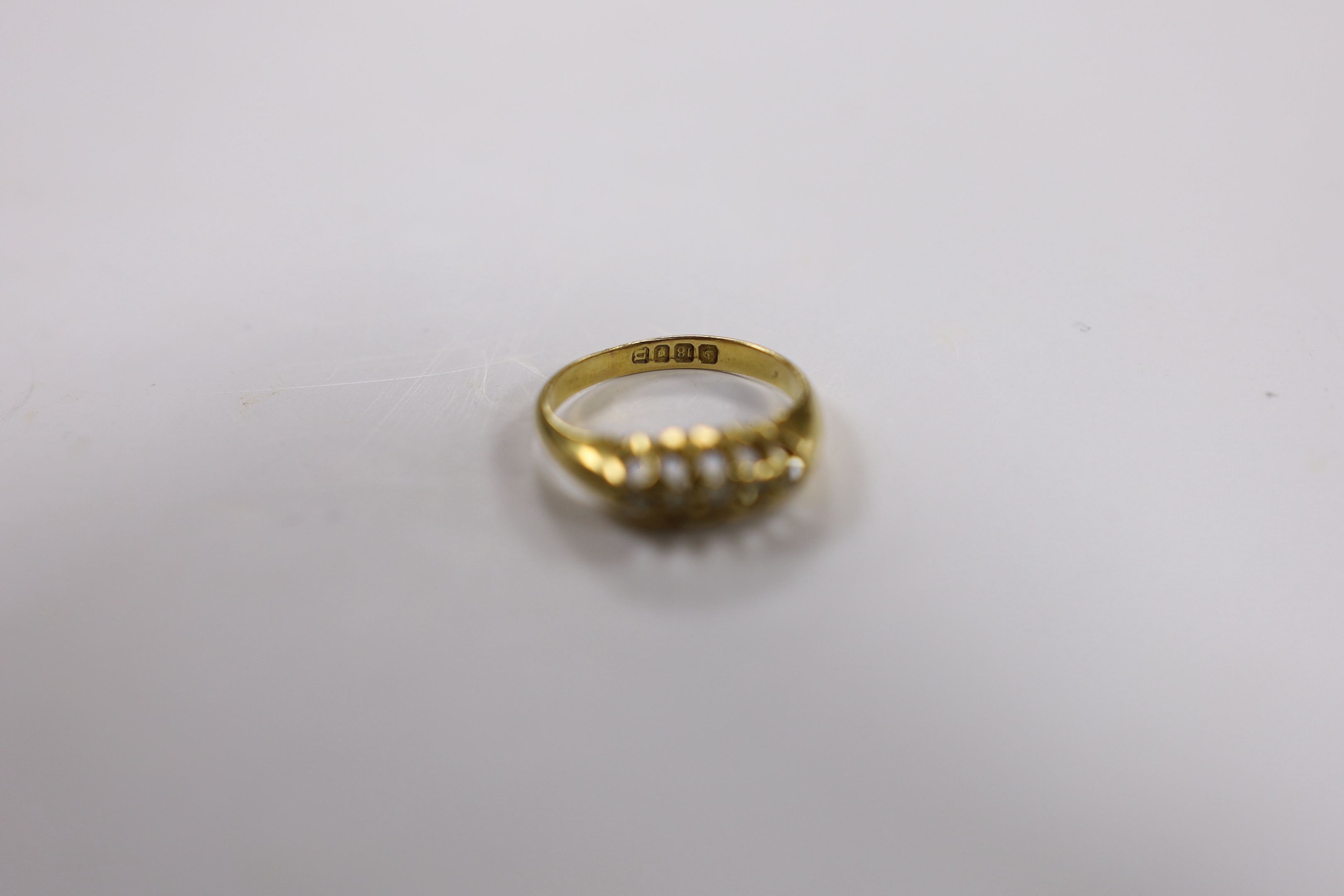 A George V 18ct gold and five stone diamond chip set half hoop ring, size M, gross weight 3.1 grams.
